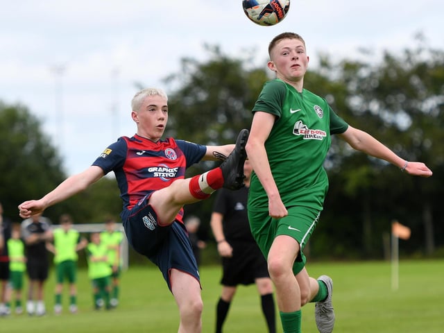 Cliftonville under-14's player Nathan McAteer wins this tussle with Clooney FC player Alexander Devine. (Photo: Keith Moore)