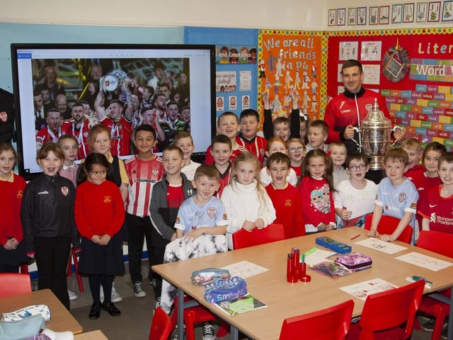 Mrs O'Doherty and her P4 class pictured with the Shane and Patrick McEleney and the FAI Cup during a visit to Steelstown Primary School this week. (Photo: Jim McCafferty)