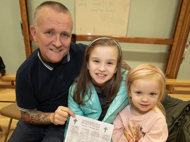 St. Joseph's Boys School teacher Gerry McBride pictured with his two daughters at the school's Wheel of Fortune' on Thursday night.