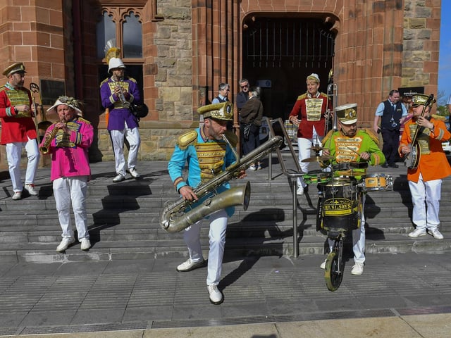 Mr Wilson’s Second Liners perform on the steps of the Guildhall. Photo: George Sweeney