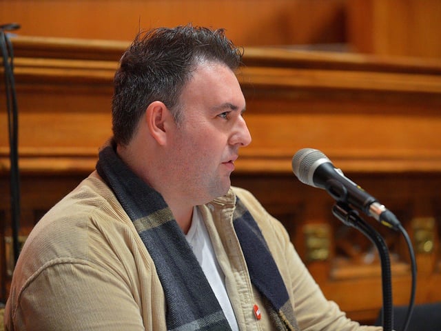 Radio Foyle NUJ representative Dean McLaughlin speaking a public meeting, held in the Guildhall on Wednesday evening, opposing planned cuts to jobs and services at BBC Radio Foyle. George Sweeney. DER2301GS – 19