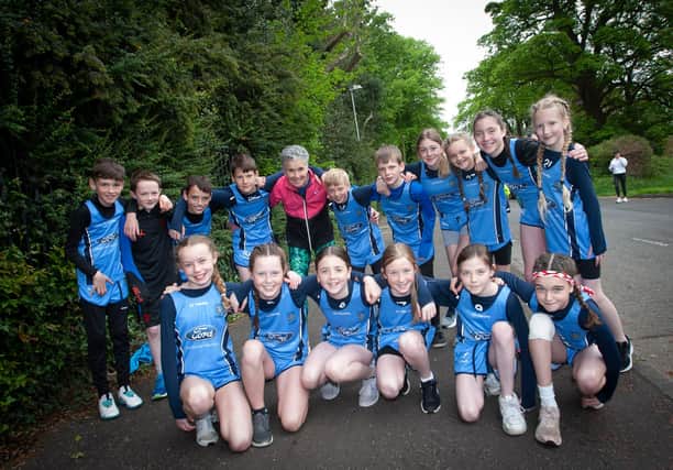 The legend that is Roisin Lynch pictured with the Hollybush Cross Country team on Friday. (Photos: jim McCafferty Photography)