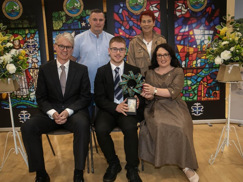 Mrs. Caroline McLaughlin, Principal, presenting the Dr Michael North Prize for Science to Caiden Morrison. On left is Mr. Brendan McGurk, KC, guest speaker and past pupil. At back are Caiden's parents Michael and Wendy.
: .