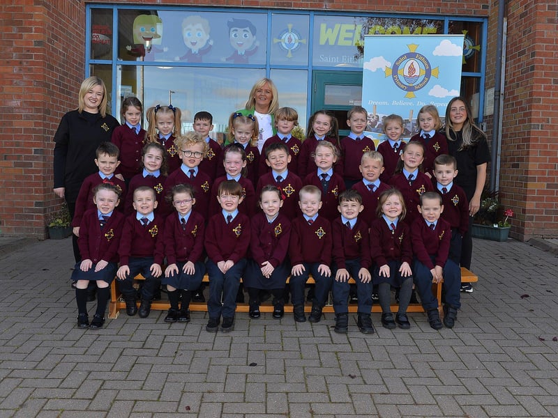 Teacher Mrs Flanghan (centre) with P1 pupils and classroom assistants at St Eithne’s Primary School.