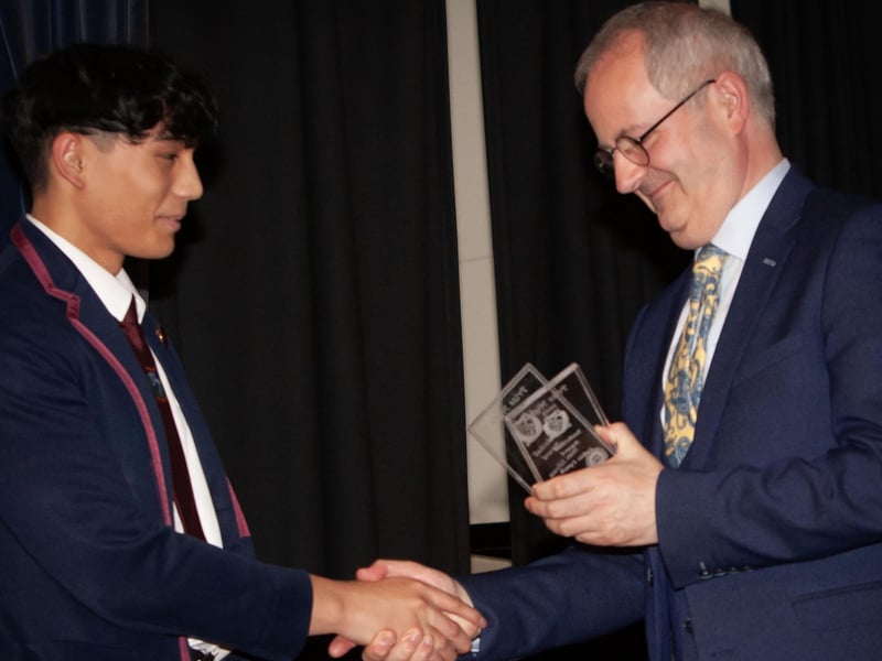 Mr. John Harkin, Principal, Oakgrove Integrated College presenting senior prizes to students.