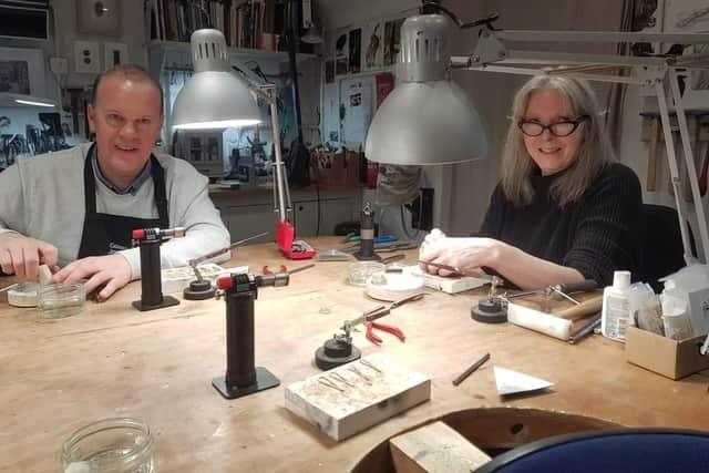 The Journal's Michael Wilson tries his hand at silversmithing under the watchful eye of Heather McFadden at Gobbins Crafts.