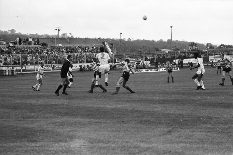 António Veloso heads the ball clear.