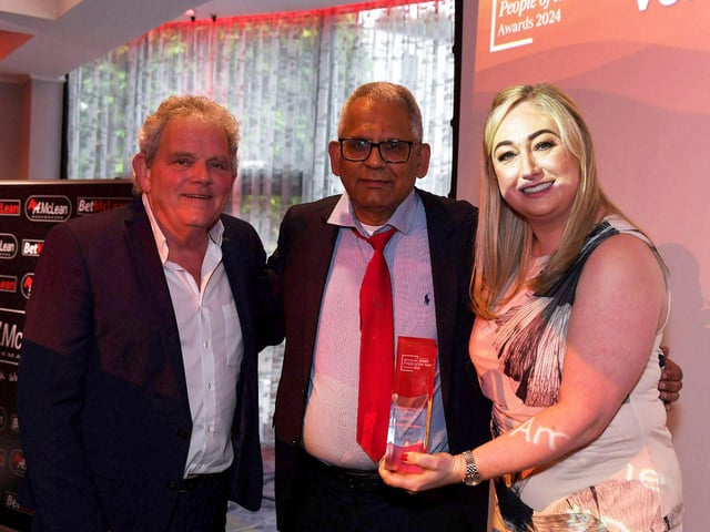 Volunteer of the Year Award winner Amerjit Singh Nagra receives his award from the Derry Journal's Louise Strain and compere Adrian Logan. Photo: George Sweeney