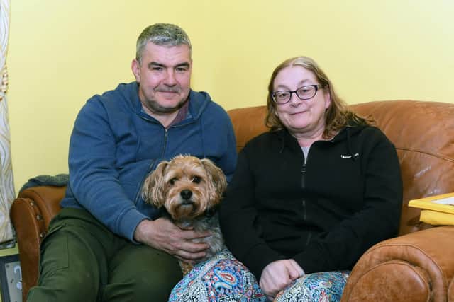 Danny and Kate Rafferty with their dog Ed pictured in their home on Beragh Hill Road. Photo: George Sweeney