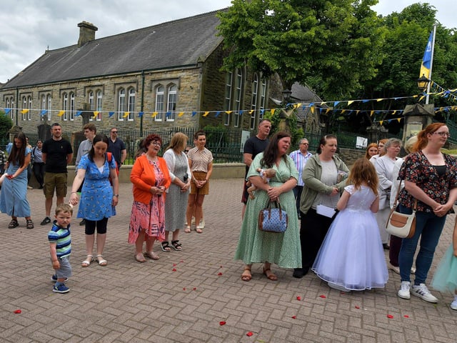 Relatives of children who made their First Holy communion recently attend the Solemnity of Corpus Christi procession in the ground of the church, on Sunday afternoon. Photo: George Sweeney. DER2324GS –