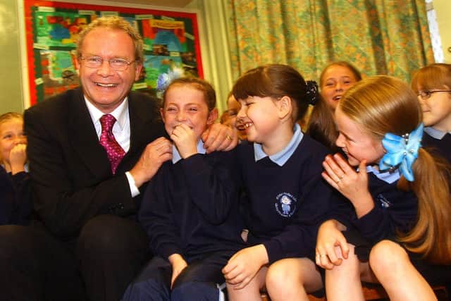 Education Minister Martin McGuinness pictured at St. Bernadette's in Ballymurphy in 2002 with pupils, Patricia McCrory, Michaela Doole and Chantelle Wally.
PHOTO STEVE WILSON/PACEMAKER
