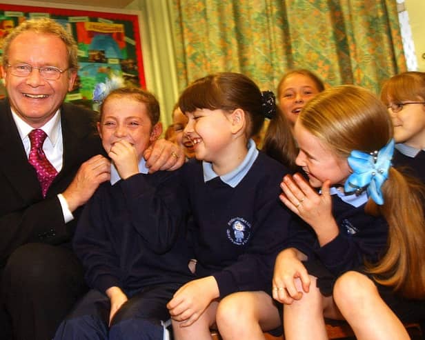 Education Minister Martin McGuinness pictured at St. Bernadette's in Ballymurphy in 2002 with pupils, Patricia McCrory, Michaela Doole and Chantelle Wally.
PHOTO STEVE WILSON/PACEMAKER