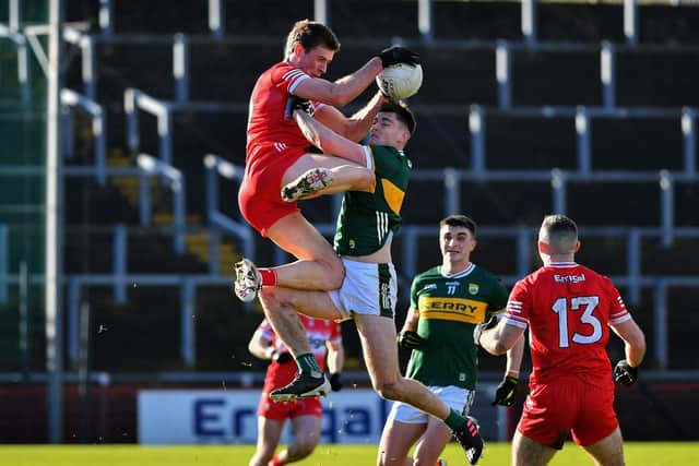 Derry’s Anton Tohill wins the ball ahead of Kerry Diarmuid O’Connor. Photo: George Sweeney
