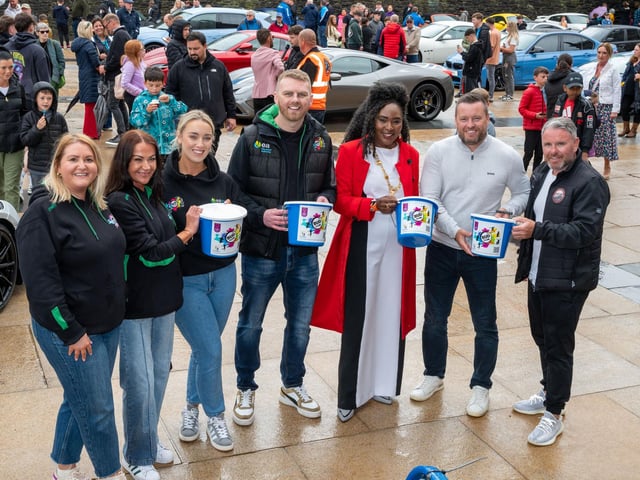 Organisers Gary McCaul and Stephen McCaul with Derry City and Strabane District Council Mayor, Councillor Lilian Seenoi-Barr and Gavin Melly, Clare Quinn, Ciora Donnellly and Amy Harkin from BUD Club, as she hosted Supercar Saturday in Guildhall Square to raise money for the Mayoral Charity Bud Club. The event attracted car enthusiasts and owners from across the region to support aid the local charity. Picture Martin McKeown. 24.05.25