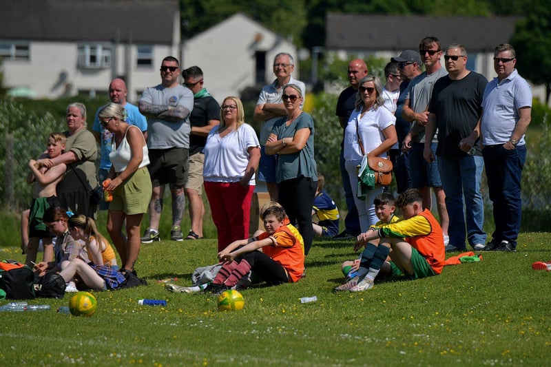 Spectators enjoy the sunshine and soccer at the D&D Championship Summer Cup finals at Prehen on Sunday morning last. Photo: George Sweeney. DER2322GS - 52