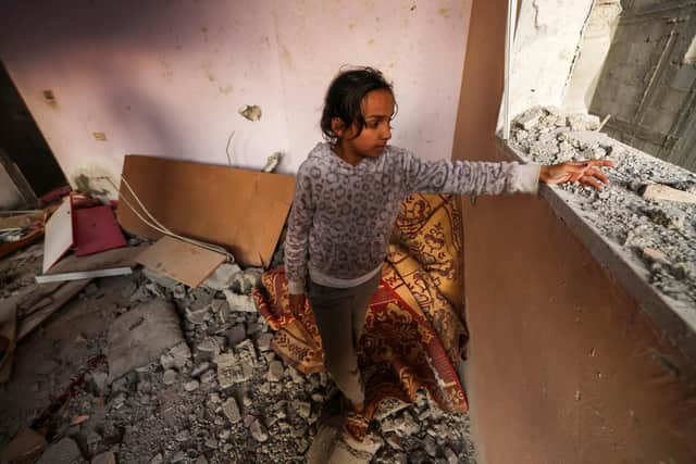 A girl reacts standing in a house destroyed by Israeli bombardment in Rafah refugee camp, south of the Gaza Strip, on January 1, 2024, amid the ongoing conflict between Israel and the Palestinian militant group Hamas. (Photo by AFP) (Photo by -/AFP via Getty Images)