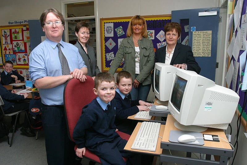 Hollybush Primary School's PTA have donated 28 computer desks and chairs to the school and watching pupils Oran Melaugh and Joshua McIntyre at work on computers in their classrooms are teacher Patrick McGarrigle, ICT Co-ordinator, PTA members Angela Doherty and Frances Bell and acting principal Crea Harkin.