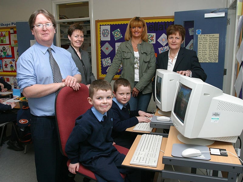 Hollybush Primary School's PTA have donated 28 computer desks and chairs to the school and watching pupils Oran Melaugh and Joshua McIntyre at work on computers in their classrooms are teacher Patrick McGarrigle, ICT Co-ordinator, PTA members Angela Doherty and Frances Bell and acting principal Crea Harkin.