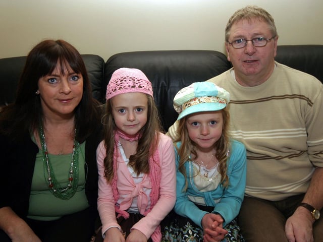 Nikky and Karli pose for the photographer with mum Jackie and dad John 0210JML : Parties and celebrations January 2006: Karli Nicky Powell.