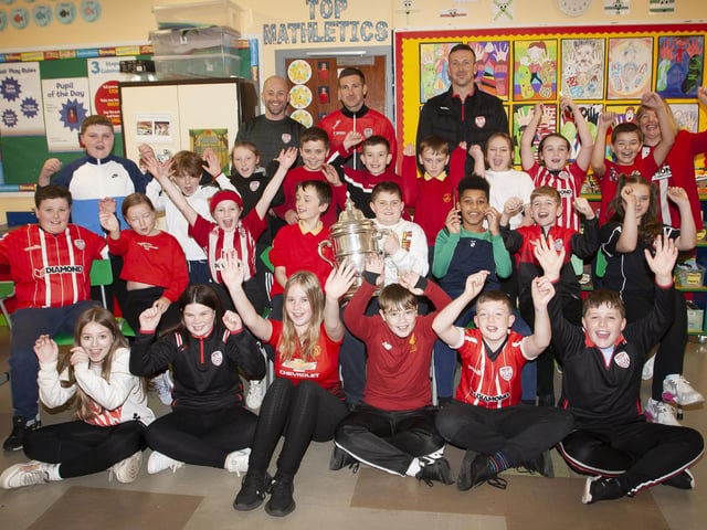 Mr. Feeney and his Primary 7 class celebrate the visit of the FAI Cup and former pupils, Shane and Patrick McEleney. (Photo: Jim McCafferty)