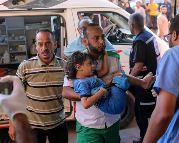 KHAN YUNIS, GAZA - OCTOBER 26: Palestinians injured in Israeli air raids arrive at Nasser Medical Hospital on October 26, 2023 in Khan Yunis, Gaza. Heading into a third week of heavy bombing from Israel, Gaza buckles under a shortage of basic needs including fuel, whilst several neighbourhoods on the Gaza strip have been wiped out and thousands have died and hundreds of thousands have been displaced. On October 7, Hamas launched a deadly attack in southern Israel that sparked a retaliatory siege of Gaza. (Photo by Ahmad Hasaballah/Getty Images)