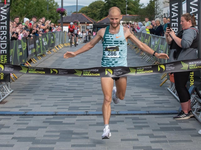 Kyle Doherty begins his celebrations as he claims the 2023 Waterside Half Marathon Mens title on Sunday. Picture Martin McKeown. 03.09.23