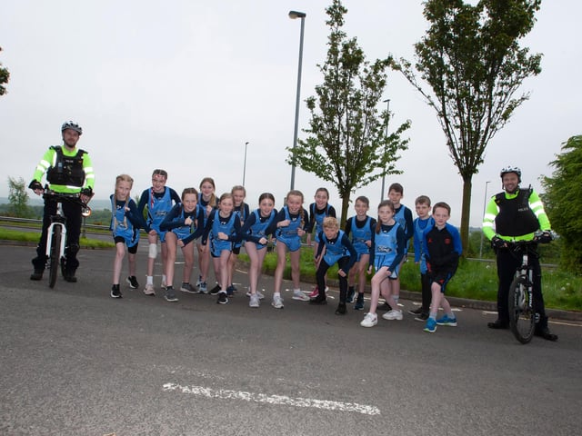 The Hollybush PS cross country team pictured with the Neighbourhood Police Safety Officers on Friday.
