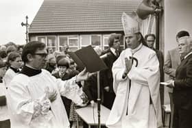 Reverend Dr Edward Daly, Bishop of Derry, blessing the school during its official opening in 1975.