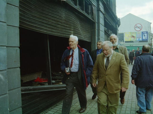 British Labour MP Tony Benn surveying the fire damaged premises of What Everyone Wants after overnight rioting with Gerry McLaughlin, Barney O'Hagan and Robin Percival.