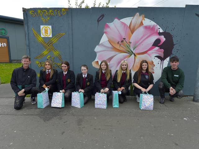 Pictured are the artists involved in the creation of the Glenabbey Art/Mural project, adjacent to Lynch’s Eurospar, Year 10 students from St Brigid’s College alongside Donal Doherty (left) and Mark Payne from the Peaball Collective.  Photo: George Sweeney