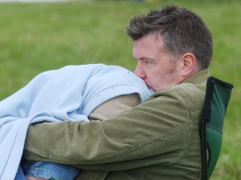 The Undertones bassist Michael Bradley keeps his son, Frank, warm. (0209C53)