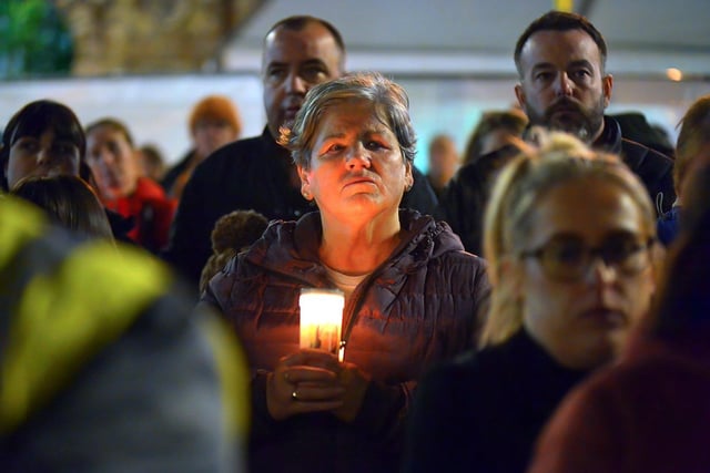 A woman carries a lighted candle at a vigil, held in Guildhall Square on Monday evening, to remember those who died in the Creeslough tragedy on Friday afternoon last.  Photo: George Sweeney.  DER2241GS – 56
