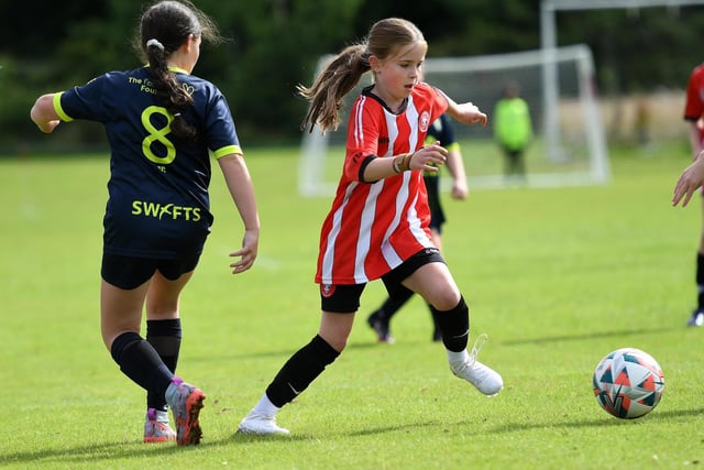 Tristar's Clara O'Doherty skips past Sion Swifts player Eve Connolly during their Girls Under-11 match at Wilton Park.