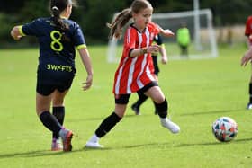 Tristar's Clara O'Doherty skips past Sion Swifts player Eve Connolly during their Girls Under-11 match at Wilton Park.