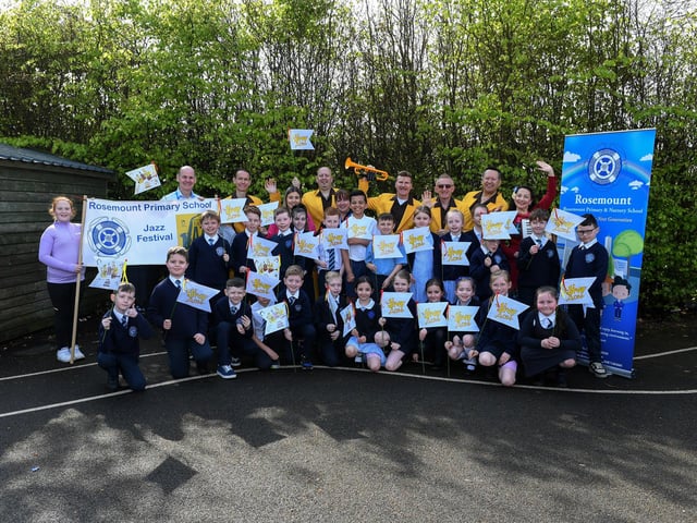 The Jive Aces pictured with pupils and staff at Rosemount Primary School on Thursday morning. Photo: George Sweeney