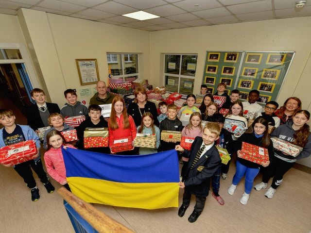 Pupils from Lumen Christi College pictured with some of the hundreds of Christmas presents for Ukrainian children donated by pupils, their families and friends. Included in the photograph are Peter Jennings, Derry Ukraine Aid, Deputy Mayor Alderman Niree McMorris and teacher Mrs Bronagh Gormley. Photo: George Sweeney