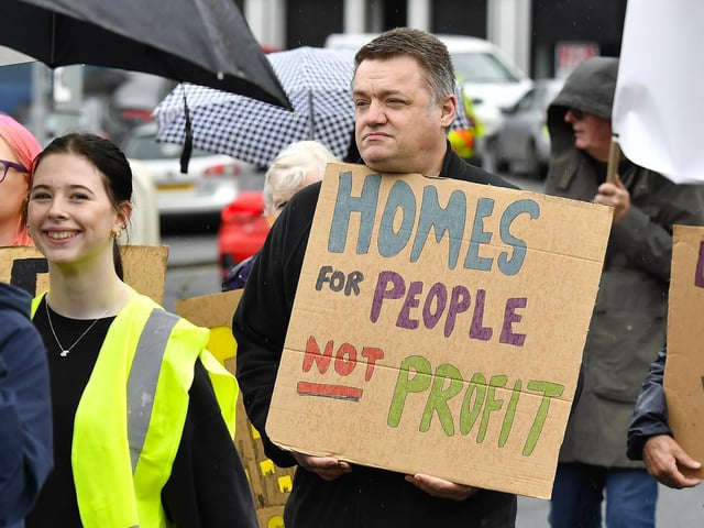 Participants carry placards during the Derry Housing Action Committee protest march over housing crisis on Saturday afternoon Photo: George Sweeney