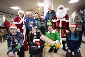 Santa, Mrs. Claus and Little Helpers pictured with one of the families at Santa Saturday. (Photos: Jim McCafferty Photography) : .