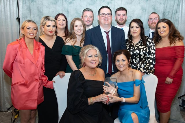 Sharon McDaid presents Mary McLaughlin and her staff with the Pub of the Year Award sponsored by Neal Doherty's Jewellers at the Carndonagh Traders Business and Community Awards in the Ballyliffin Lodge Hotel on Saturday night last. Photo Clive Wasson.