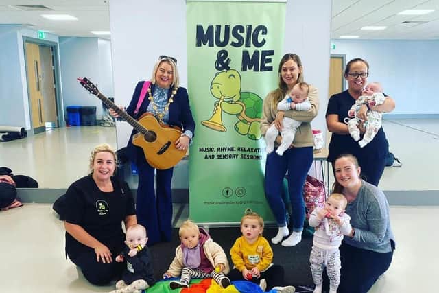 Mayor Sandra Duffy with babies and parents from 'Music and Me', who will be performing at the Mayor's 24 Busk for Homelessness