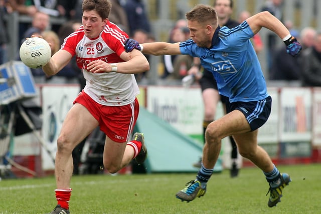 Derry's Declan Mullan tries to outpace Dublin's Jonny Cooper during the 2014 Division One clash in Celtic Park.  (Photo Lorcan Doherty / Presseye.com)