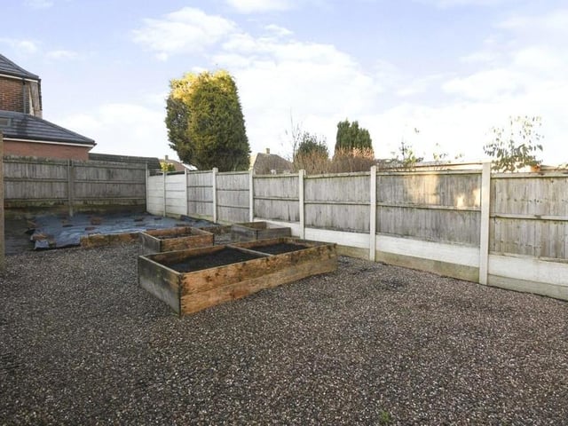 The garden at the back of the £200,000 property is mainly paved, with raised beds.