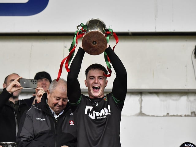 Slaughtmanus captain Oran Carton lifts the Derry Junior Football Championship Joe Brolly Cup at Celtic Park. Photo: George Sweeney