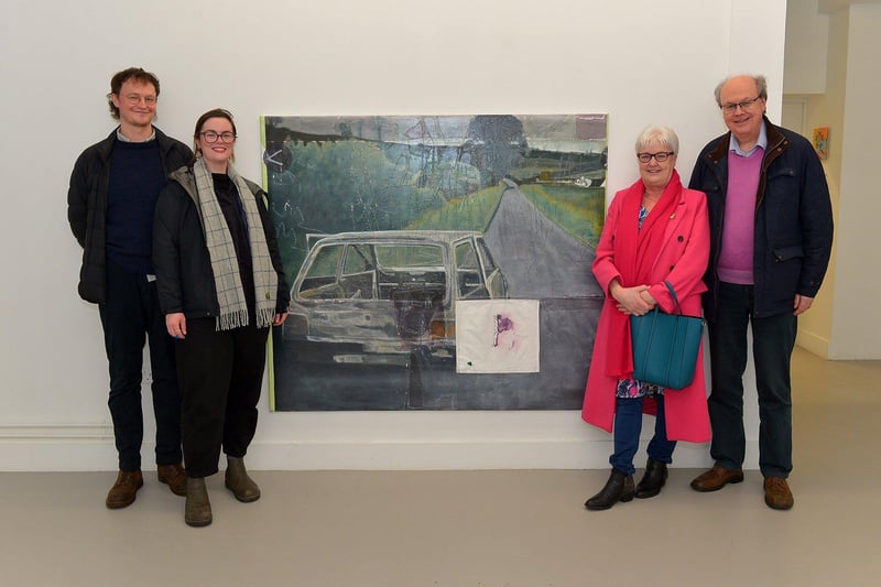 Visitors view Derry born Richard Magee, left, pictured with his girlfriend Genevieve Slater and his mum and dad Pamela and Trevor beside his exhibit ‘Ghost in a machine says some thing’s in the way (after Willie Doherty) exhibit at the Centre for Contemporary Art’s ‘Urgencies’ Exhibition which runs until 18th March next. Richard now lives and works in Hamburg. Photo: George Sweeney. DER2304GS – 32