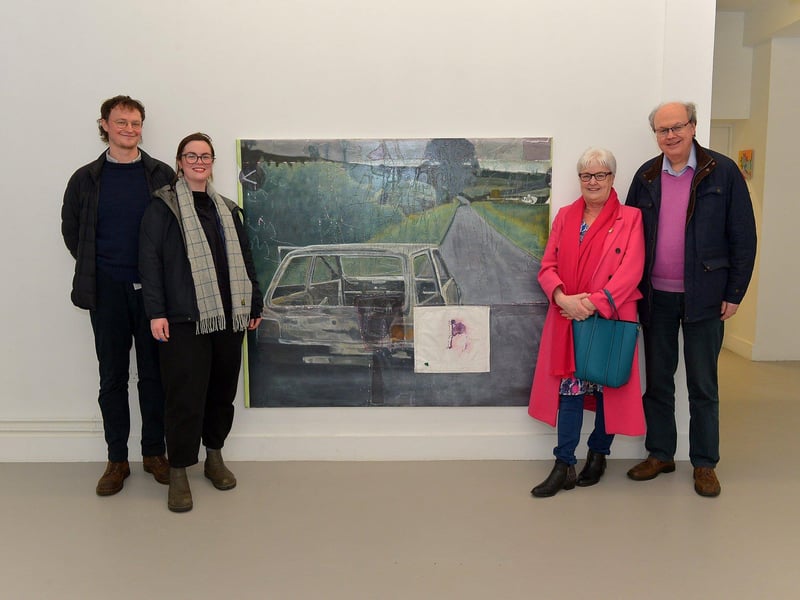 Visitors view Derry born Richard Magee, left, pictured with his girlfriend Genevieve Slater and his mum and dad Pamela and Trevor beside his exhibit ‘Ghost in a machine says some thing’s in the way (after Willie Doherty) exhibit at the Centre for Contemporary Art’s ‘Urgencies’ Exhibition which runs until 18th March next. Richard now lives and works in Hamburg. Photo: George Sweeney. DER2304GS – 32
