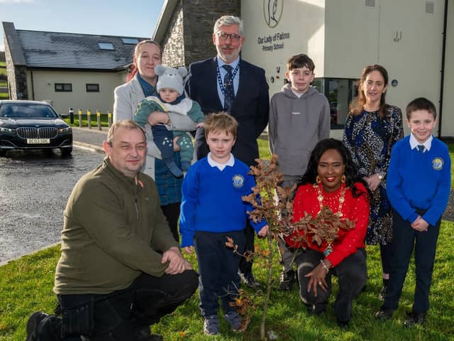 Mason Duddy pictured with his brothers, Caiden, 12, Blake, 5 months and Logan, 8 and his mum Michaela with the tree which was planted at his school, Our lady of Fatima PS, Tamnaherin as part of the Life Tree Project which sees an Oak tree planted for every Birth, Death and Marriage recorded in the Derry City and Strabane District Council Area. Mason planted an Oak sapling for his brother Blake with the help of the Mayor, Councillor Lilian Seenoi-Barr, Councillor Declan Norris, Principal Jack Logue and Mrs Mairead Conway, class teacherr. Picture Martin McKeown. 25.11.24