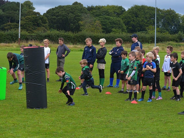 Participants at the recent City of Derry Youth Rugby Summer Camp practise tackling with City of Derry senior player CJ Cregan. Photo: George Sweeney. DER2331GS – 57