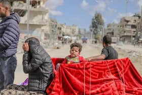 Displaced Palestinians who left Rafah in the southern Gaza Strip following an evacuation order by the Israeli army, arrive at Khan Yunis with their belongings on May 6, 2024. On the same day, Hamas announced it had accepted a truce proposal. (Photo by Khames Alrefi / Middle East Images / Middle East Images via AFP) (Photo by KHAMES ALREFI/Middle East Images/AFP via Getty Images)