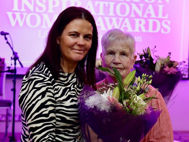 Kathleen Simpson receiving her presentation from Aine Doherty, daughter of Roisin Barton.