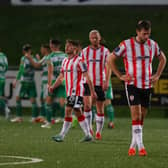 Derry City players are despondent as Shamrock Rovers celebrate a big win at Brandywell. Photographs by Kevin Moore.